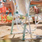 Detailed shot of the Freestyle Rocker's spring-loaded base with floral pattern and soft green frame.