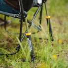 Close-up of a Freestyle Rocker’s piston mechanism on grass, showing the “Freestyle Rocker” logo in white and orange.