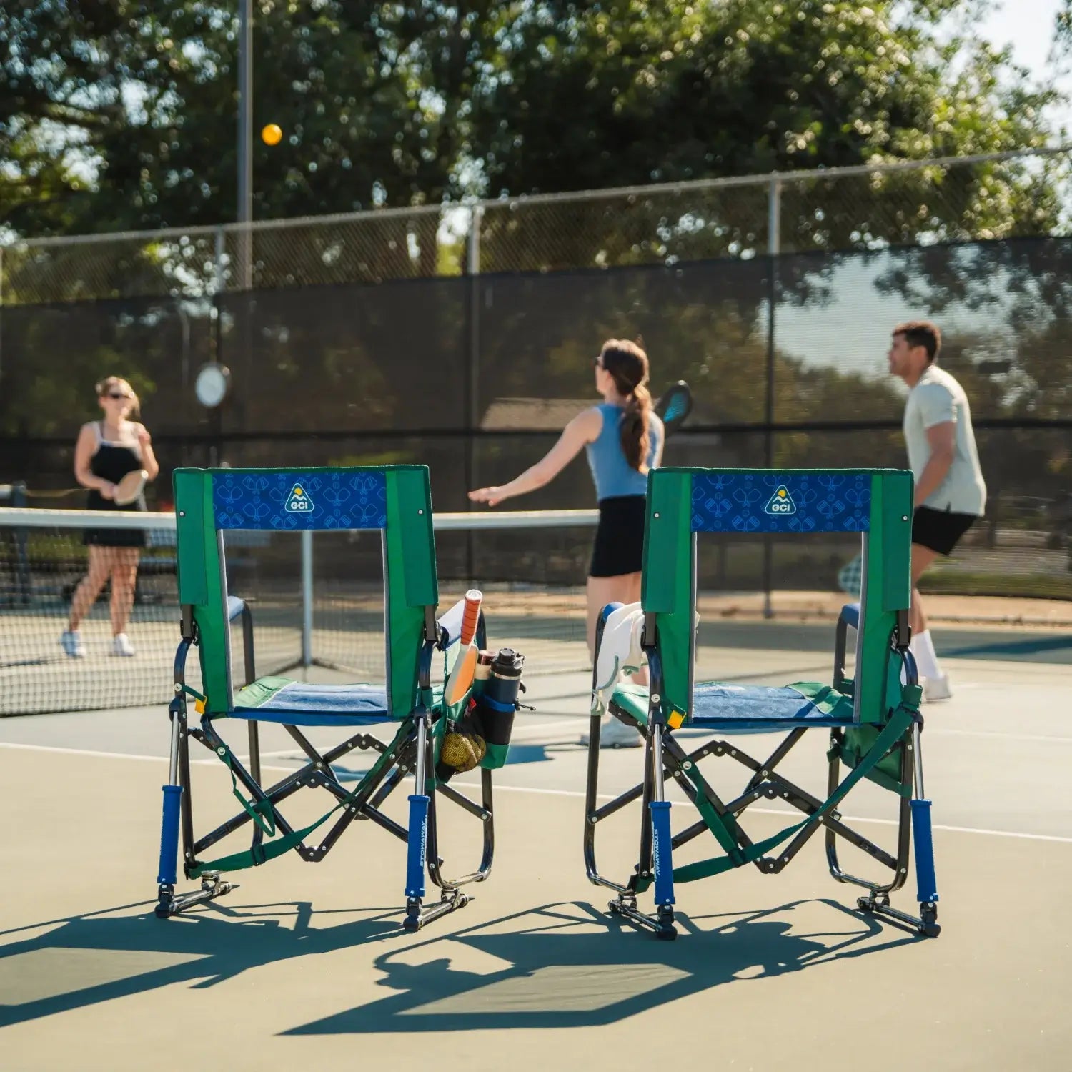 Two pickleball stowaway rockers sitting on a court.