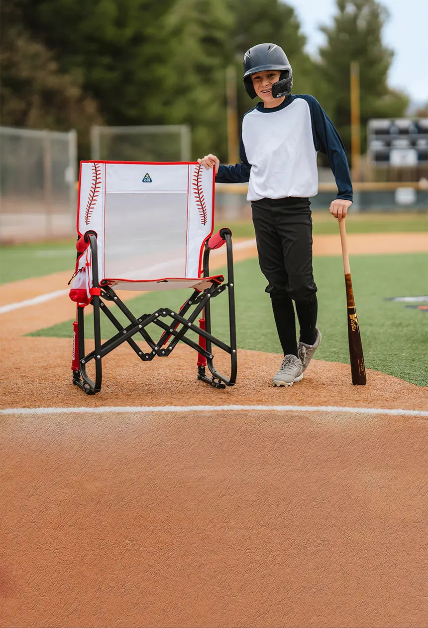 A baseball player standing next to a baseball print stowaway rocker. 